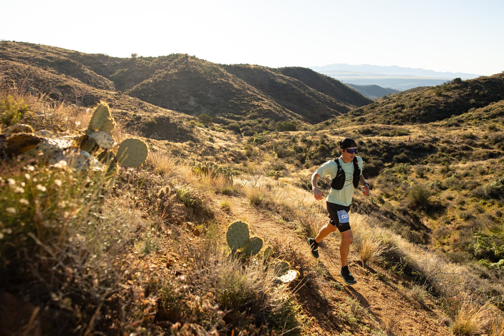 Eric running through desert terrain